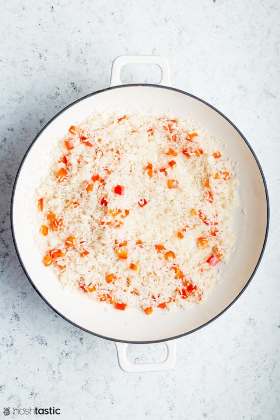 Rice and bell peppers in a pan