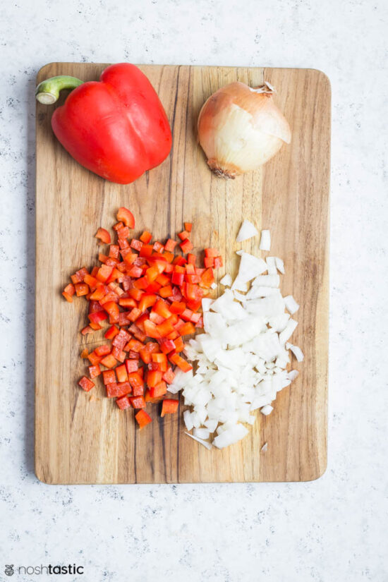 diced onion and bell peppers on wood board