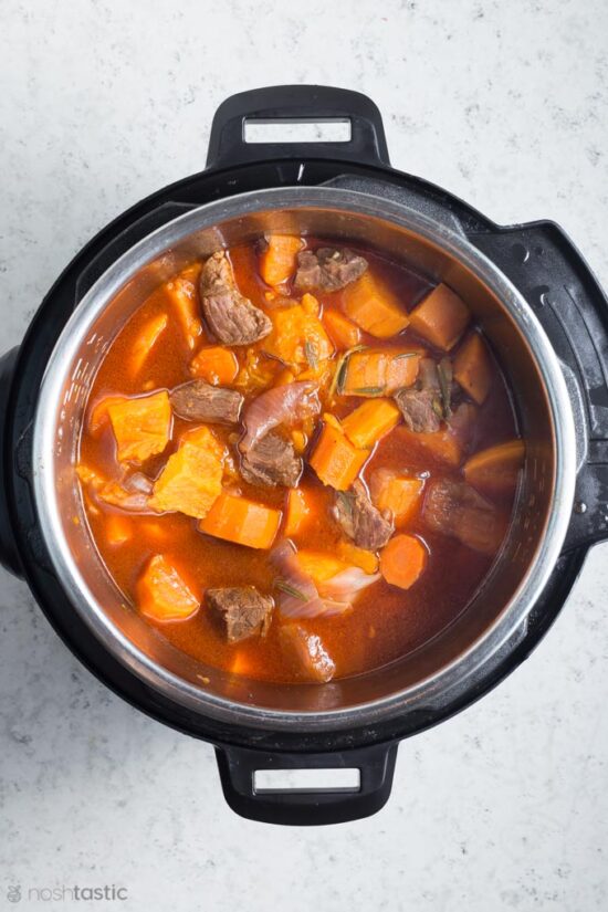 cooked beef stew inside a pressure cooker