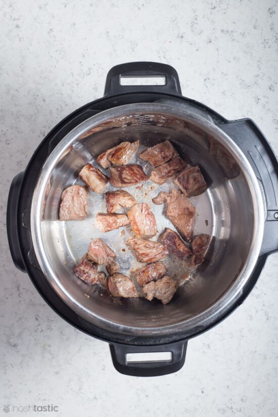 browned beef in a pressure cooker