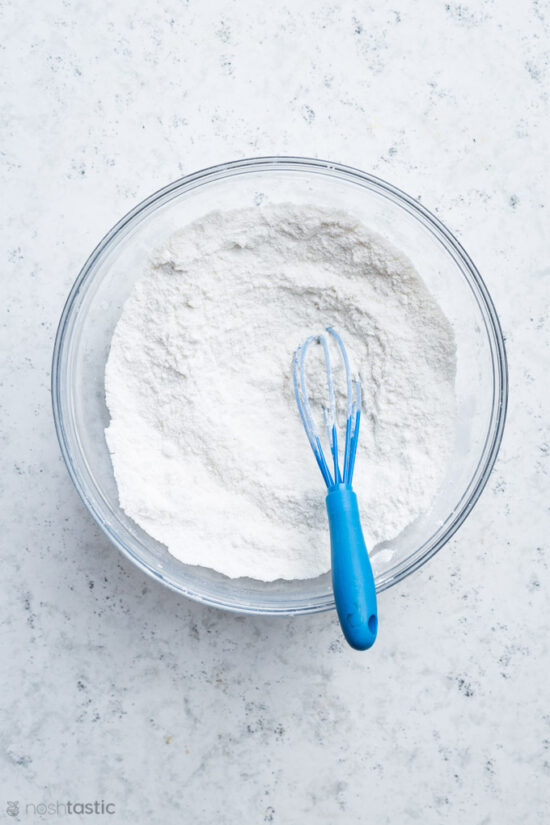 gluten free flour in a bowl with whisk