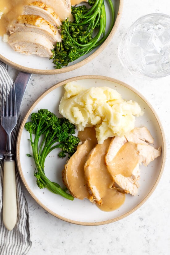 chicken broccoli and mashed potatoes and gravy on a plate