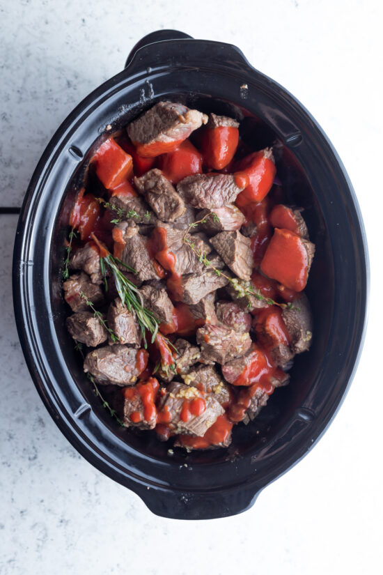 beef stew ingredients in a slow cooker