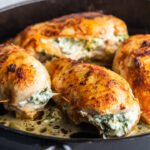 chicken stuffed with spinach in a skillet