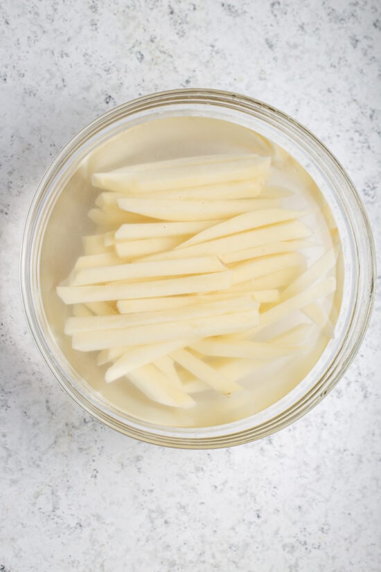 fries soaking in a bowl of water