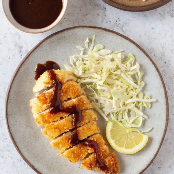 chicken katsu with shredded cabbage and lemon