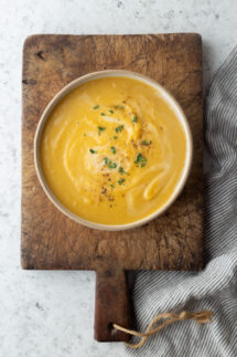 bowl of soup on a board