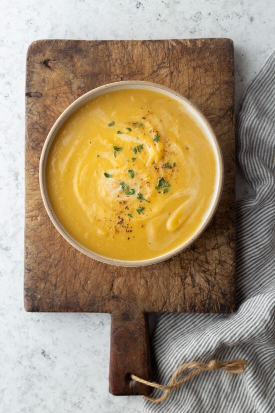 bowl of soup on a board